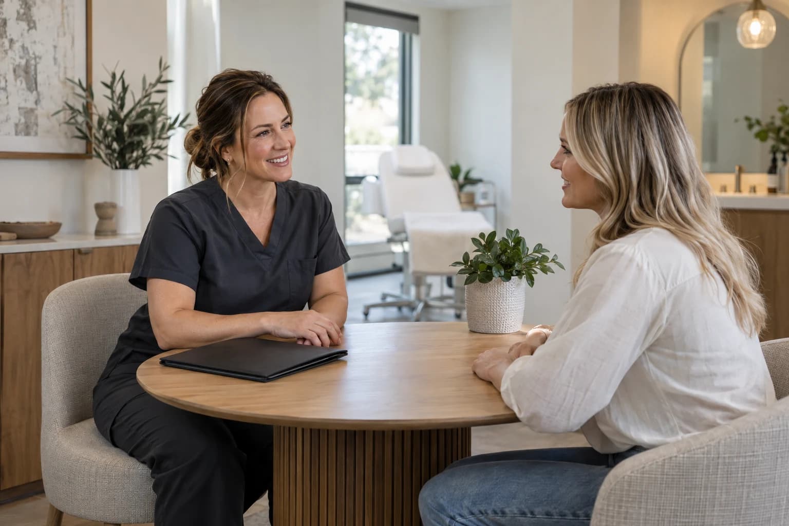 A med-spa professional welcoming a client for a consultation